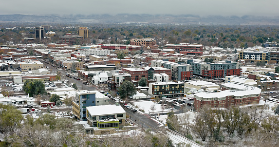 Aerial shot of downtown Fort Collins, Colorado on a snowy, overcast day in Fall.