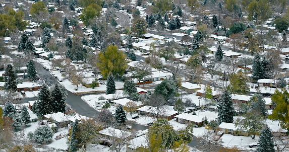 Aerial shot of houses in Old Prospect, Fort Collins, Colorado on a snowy, overcast day in Fall.