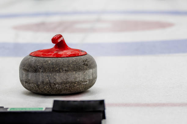 istock Curling rocks on sheet of ice 1893831002