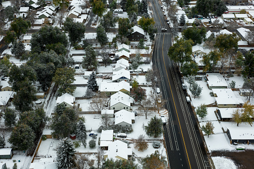Aerial shot of houses in Fort Collins, Colorado on a snowy, overcast day in Fall.
