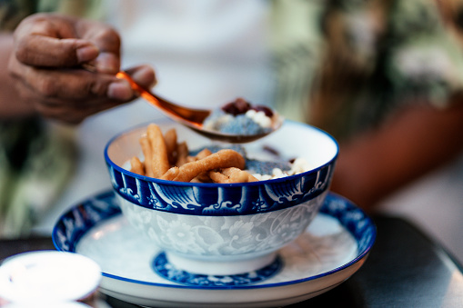 Tofu pudding in ginger syrup with deep-fried dough stick in bowl