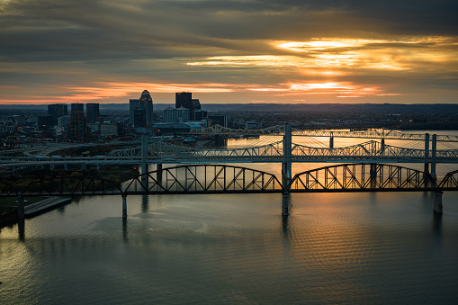 Aerial shot of downtown Louisville, Kentucky and Ohio River on a Fall sunset.\n\nAuthorization was obtained from the FAA for this operation in restricted airspace.