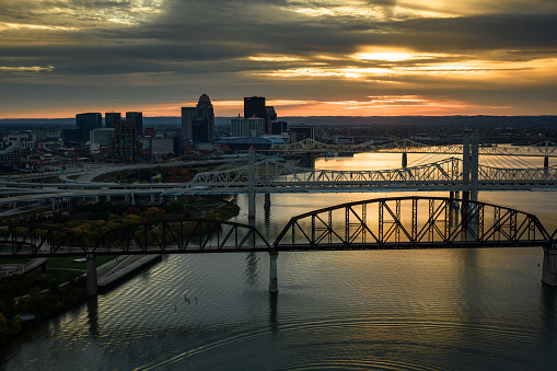 Aerial shot of downtown Louisville, Kentucky and Ohio River on a Fall sunset.\n\nAuthorization was obtained from the FAA for this operation in restricted airspace.