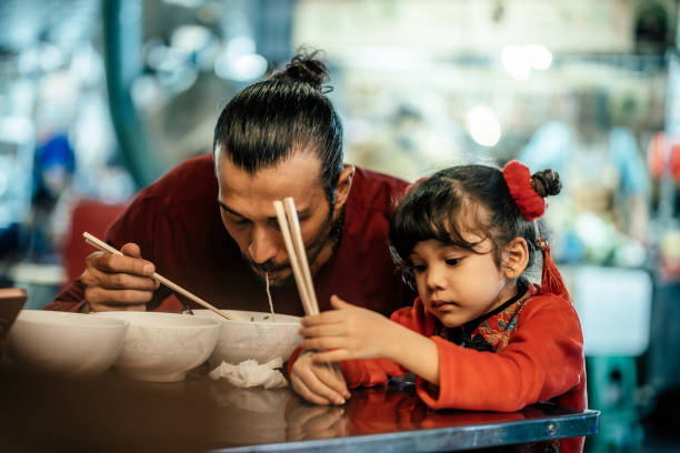 istock Father and daughter having dinner together 1893840479