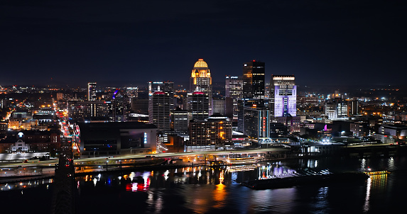 Aerial shot of downtown Louisville, Kentucky from over Ohio River on a Fall night.\n\nAuthorization was obtained from the FAA for this operation in restricted airspace.