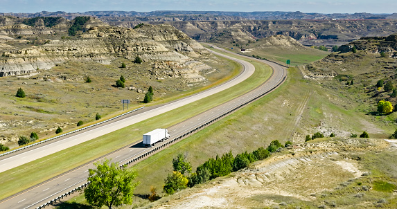 Aerial still of Interstate 94 near Medora, a city in Billings County, North Dakota, on a clear, sunny day in Fall.