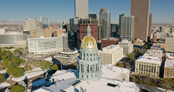 Aerial shot of the Colorado State Capitol Building in Denver, on a sunny morning in Fall after a night of snow.