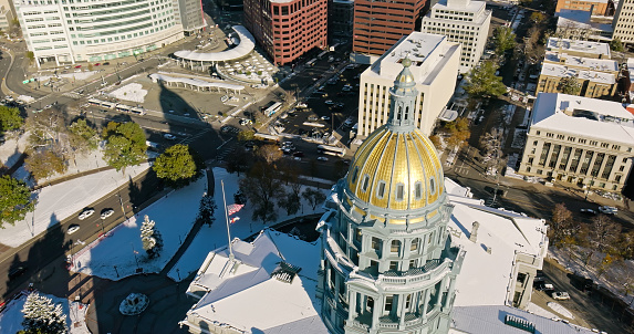 Aerial shot of the Colorado State Capitol Building in Denver, on a sunny morning in Fall after a night of snow.