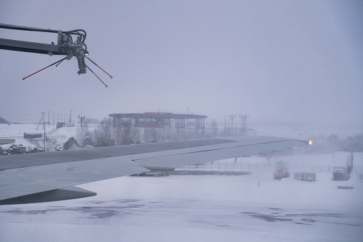 Hokkaido, Japan - December 20, 2023: De-icing an airplane at tarmac in Hokkaido, Japan