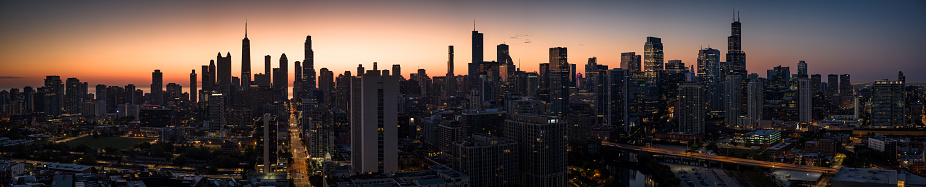 Stitched panoramic drone shot of the downtown skyscrapers of the Chicago Loop at dusk.