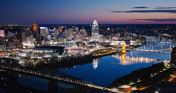 Aerial view of Ohio River flowing between Downtown Cincinnati, Ohio and Covington, Kentucky just before sunrise on a Fall morning.
