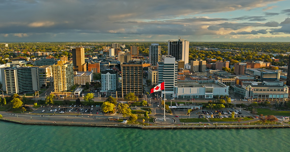 Aerial view of City Centre in Windsor, Ontario, Canada on a cloudy Fall sunset from over Detroit River, Detroit, Michigan. Please note that this shot was taken from within US airspace by a FAA licensed drone pilot.