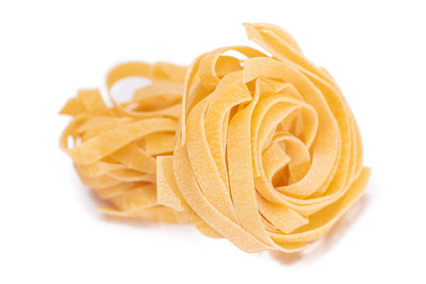 istock Two Classic Italian Raw Egg Fettuccine - Isolated on White Background 1893959856