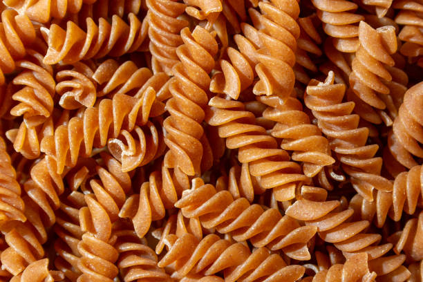 istock Uncooked Whole Grain Fusilli Pasta Background 1893976735