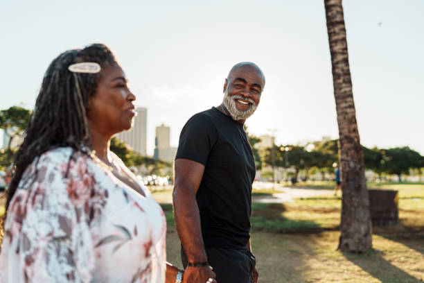 Active senior man and wife enjoying leisurely afternoon walk