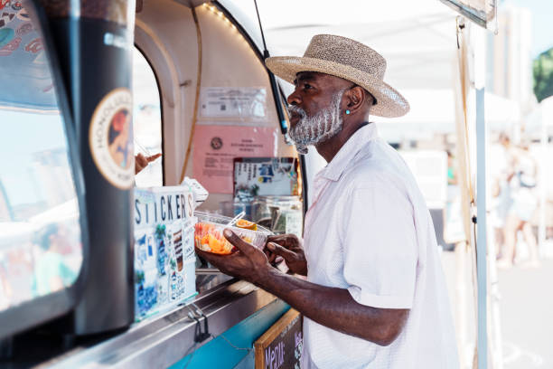 istock Senior man ordering from a food truck 1894050865