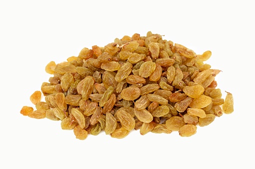 Closeup of Golden Raisin Heap Isolated on White Background with Copy Space for Texts Writing.