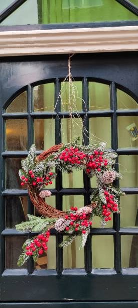 istock Christmas wreath hanging on the door 1894111305