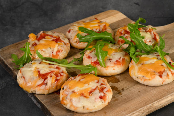 istock Mini pizza party snacks on a wooden board 1894113907