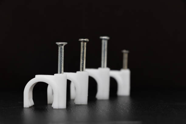 wiring stud plastic card or wiring nail or Round Cable Clips isolated on black background