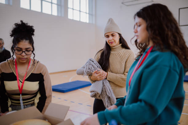 istock Volunteers sorting, packing clothes in cardboard boxes 1894191837