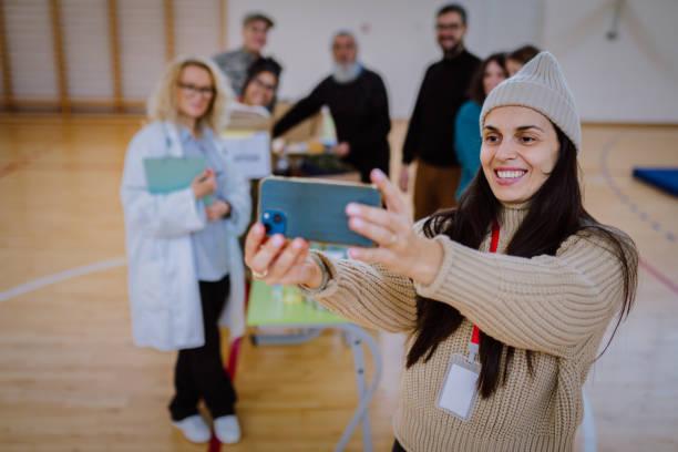 istock Volunteer and refugees take a selfie 1894193942