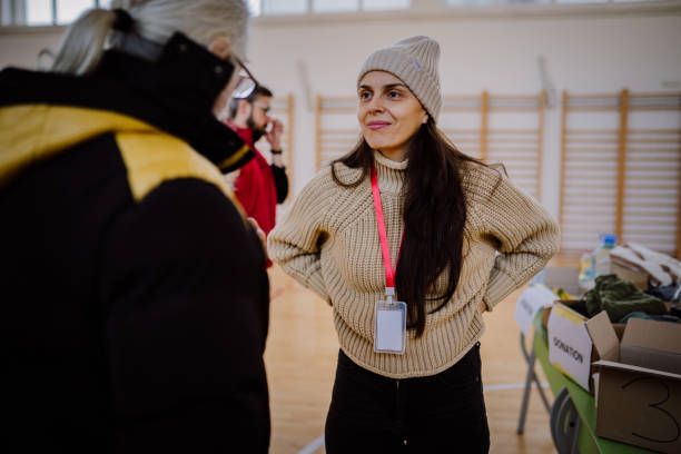 Giving donations to refugees in a sheltering