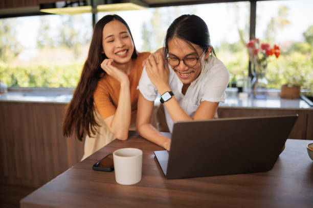 istock Smiling couple on laptop in the kitchen 1894239920