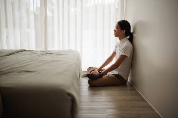 istock Man sitting lonely in bedroom 1894244564