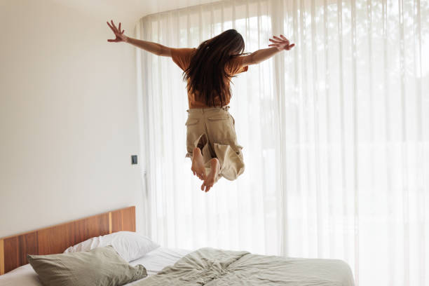 istock Joyful woman jumping with happiness 1894245081