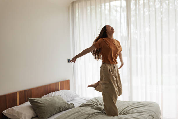 istock Joyful woman jumping with happiness 1894245592
