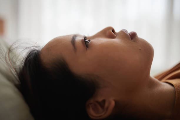 istock Woman stares pensively at the ceiling 1894246112