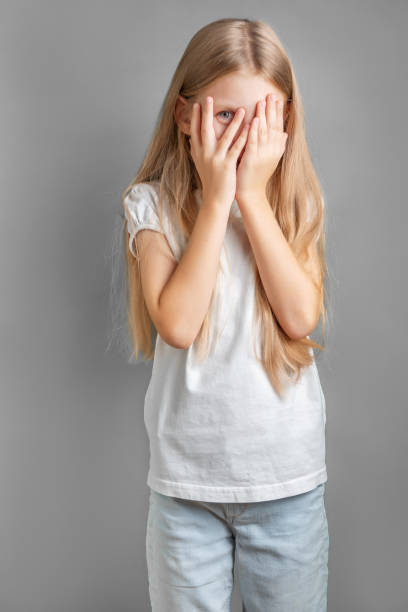istock A little girl covering her face with her hands 1894256366