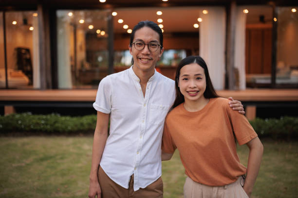 istock Smiling young couple in front of their home 1894256884