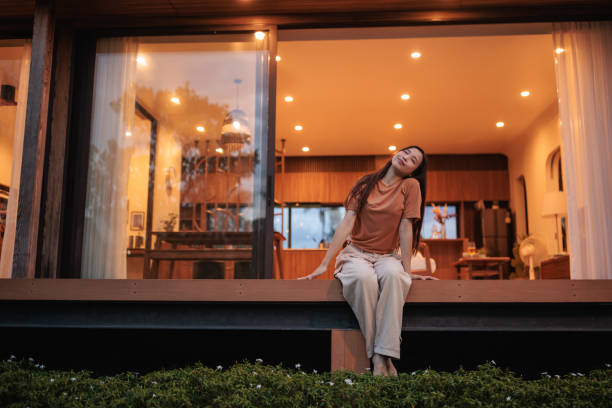 istock Smiling young woman in front of her home 1894258421