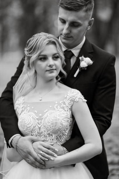 istock the groom and the bride are walking in the forest 1894367143