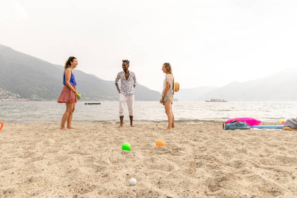 Front view, shot on the action. Two women and a man playing together
