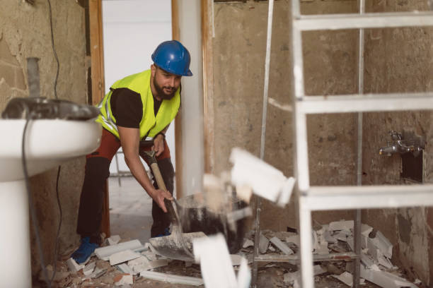 istock construction worker removes broken tiles with a shovel in a bathroom 1894390964