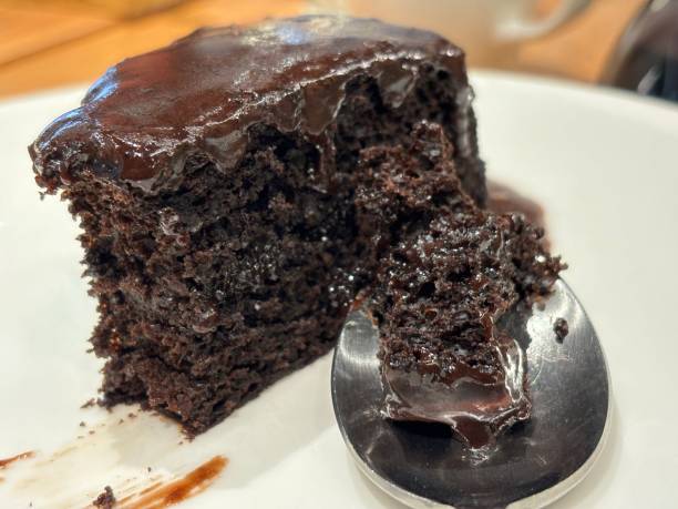 istock Chocolate sponge cake cut on white plate 1894455551