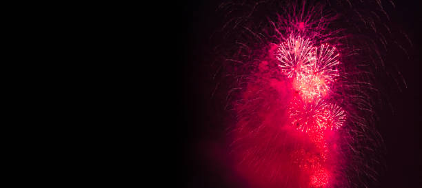 istock Holiday fireworks backgrounds with sparks, colored and bright light on black night sky, pyrotechnics. Amazing colorful fireworks at celebration, show. Holidays background concept. Copy ad text space 1894477440