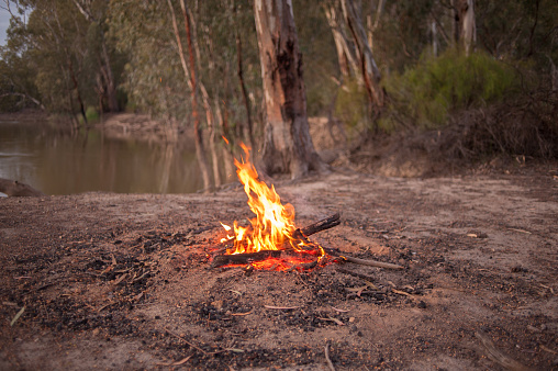 Warm glowing campfire next to the Murray River in Australia