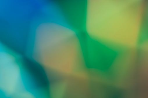 Abstract colorful background in green tones with defocused light and shadow, gradient and hologram. Backdrop. Design element.