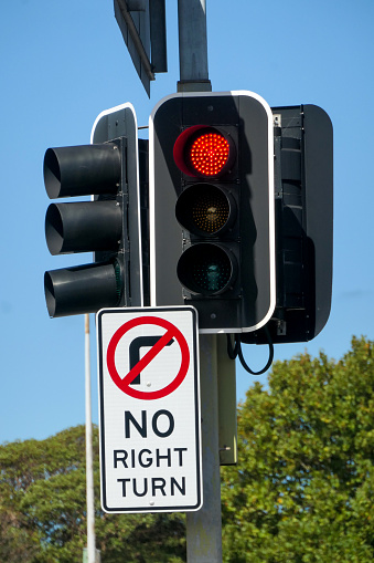 Pedestrian crossing traffic signal with timer and traffic lights at the intersection allow pedestrians and road traffic to use the crossing alternately.