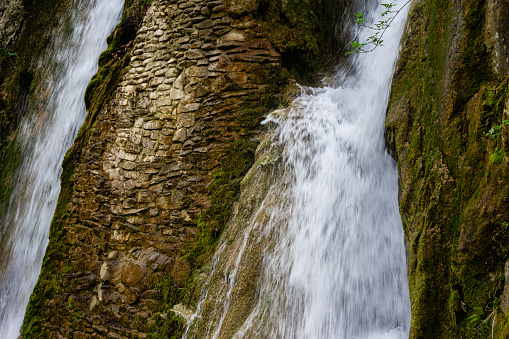 Small watefall and rocks in mountain