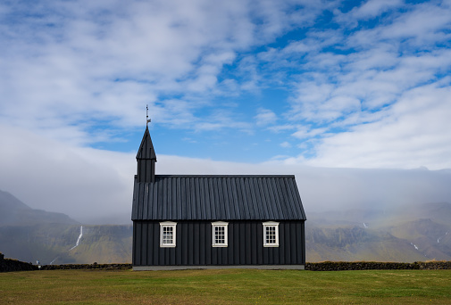Rainbow at Budir black church in Snaefellsnes peninsula, Iceland. Famous church and tourist attraction