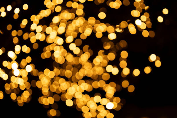istock Decorative outdoor string lights at night time, Defocused Background, night city life backdrop, party time with Yellow bokeh balls 1894617371