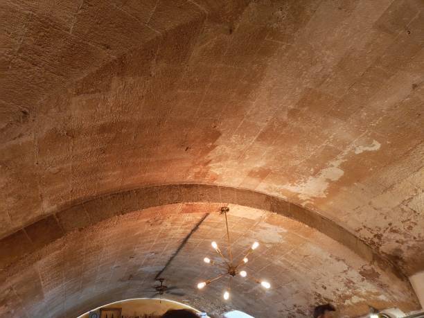 Special light on ceiling with orange "Mares" stone and a golden modern lamp
