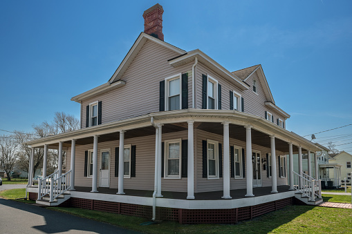 Englishtown, NJ, USA - April 14, 2018: A classic home with full wrap around porch in historic Englishtown New Jersey.