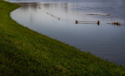 Flooded field with fence partially submerged