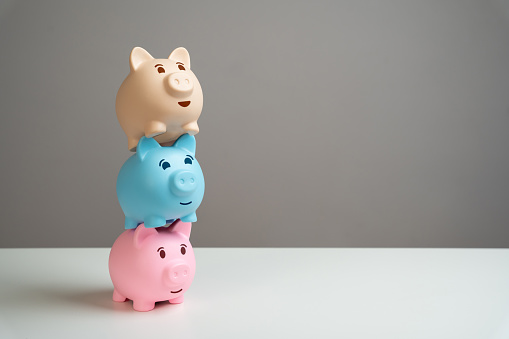 Tower of three piggy banks. Multiple deposits. Savings and deposit banking. Healthy economy. Diversification of investments and savings. Banking. Good conditions from the bank. Increase capital.